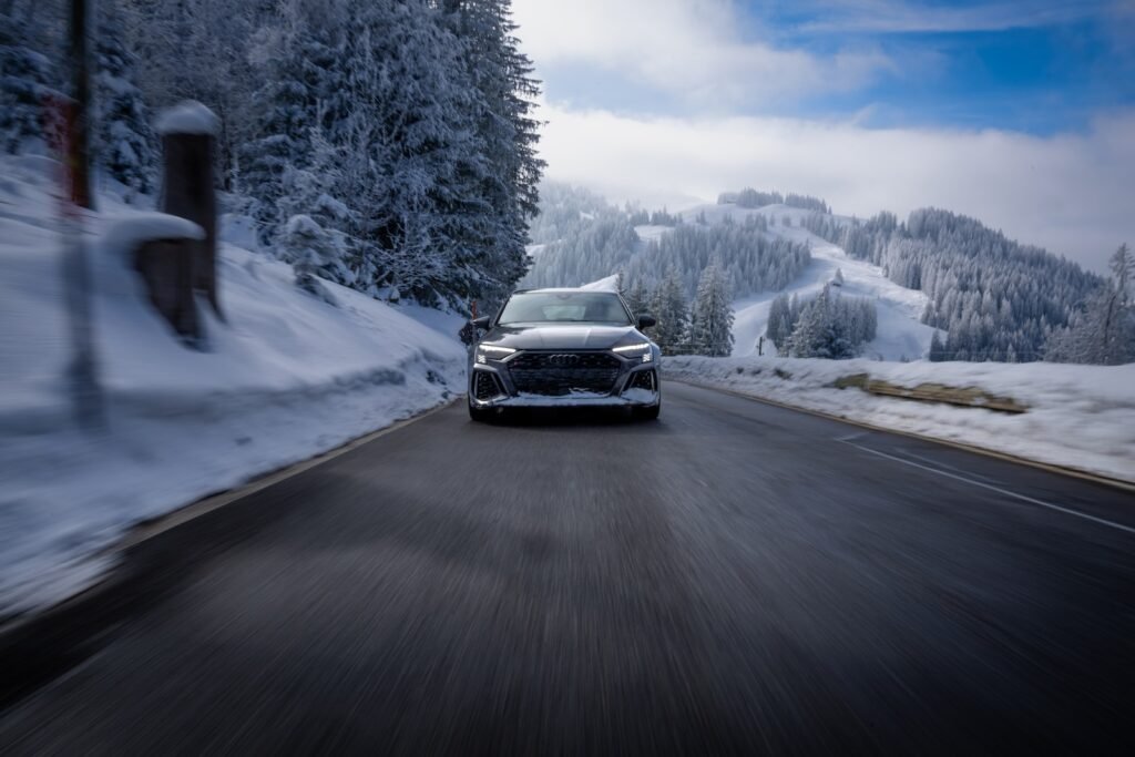 a car is driving down a snowy road